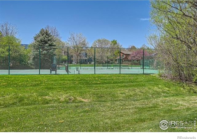 view of sport court with basketball court and a lawn