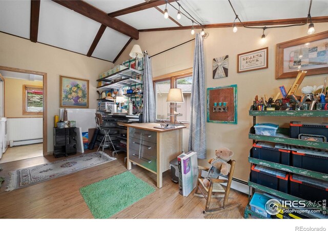 office with baseboard heating, lofted ceiling with beams, and light hardwood / wood-style flooring