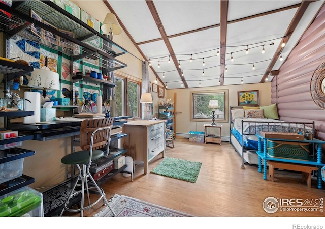 interior space featuring high vaulted ceiling, track lighting, log walls, and light wood-type flooring