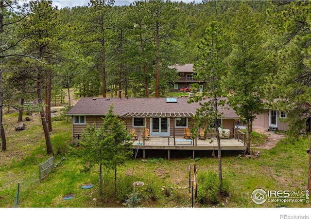 rear view of house with a wooden deck