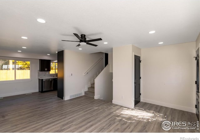 unfurnished living room featuring dark hardwood / wood-style floors and ceiling fan