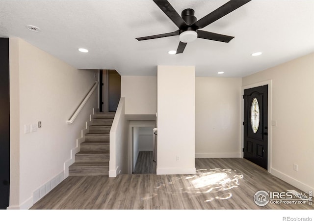 foyer with hardwood / wood-style flooring and ceiling fan