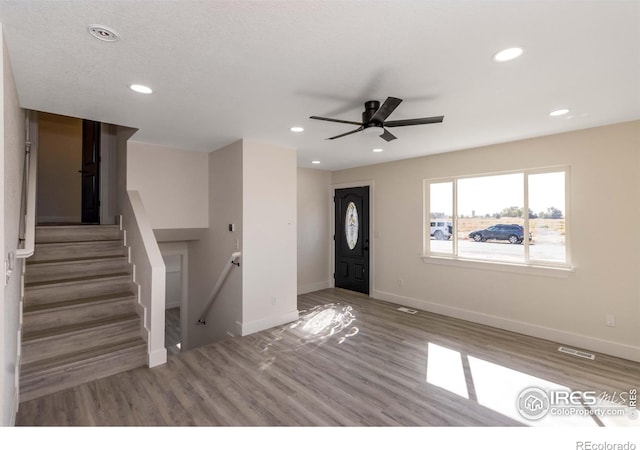 foyer entrance with hardwood / wood-style flooring and ceiling fan