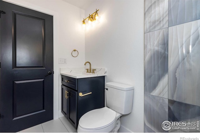 bathroom with vanity, tile patterned flooring, and toilet