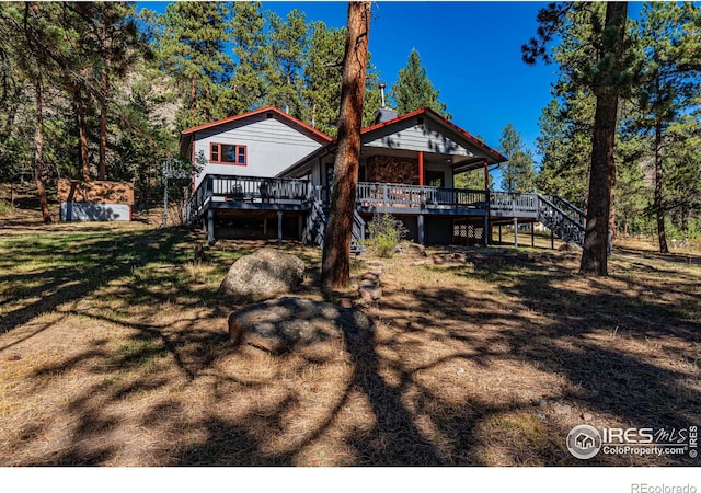 back of house with a wooden deck