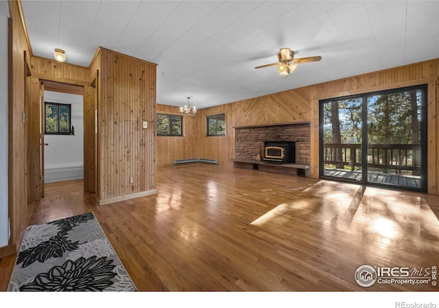 living room with plenty of natural light, wooden walls, and wood-type flooring