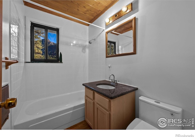 full bathroom featuring vanity, a wealth of natural light, toilet, and tiled shower / bath