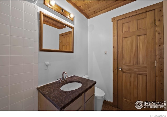 bathroom with vanity, wooden ceiling, and toilet