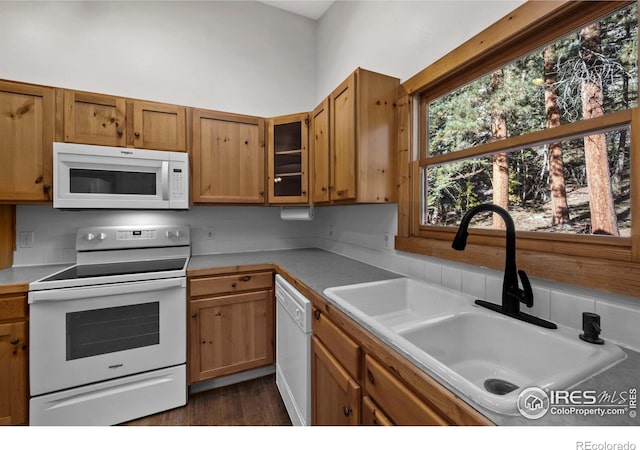 kitchen with white appliances, dark hardwood / wood-style floors, and sink