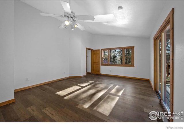 empty room featuring lofted ceiling, dark hardwood / wood-style flooring, and ceiling fan