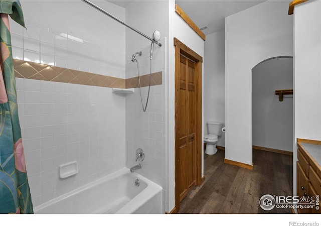 full bathroom with vanity, wood-type flooring, toilet, and shower / bath combo