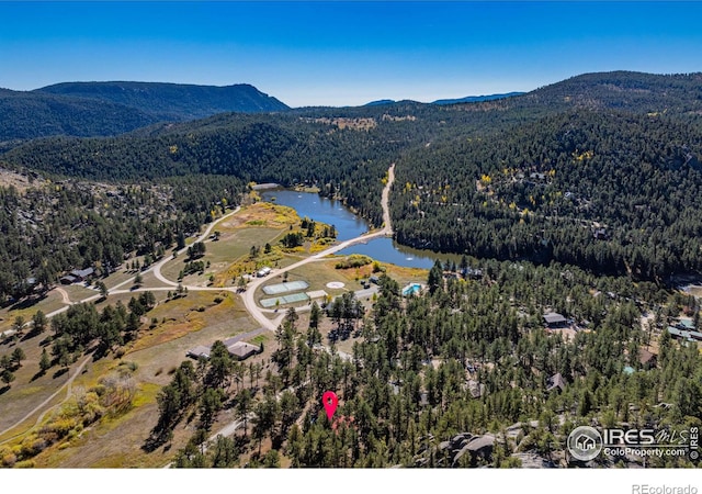 aerial view featuring a water and mountain view