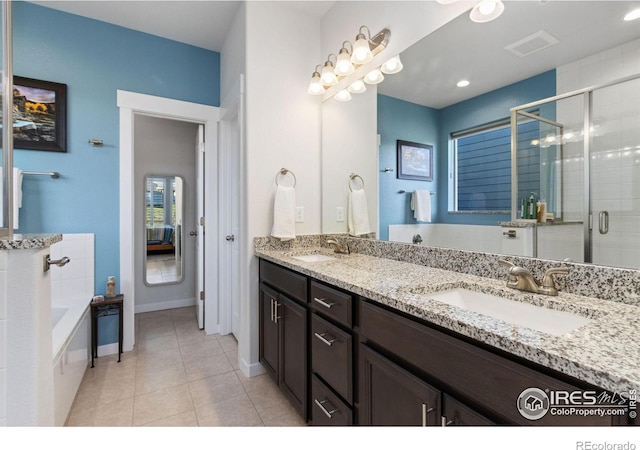 bathroom featuring tile patterned flooring, vanity, and plus walk in shower