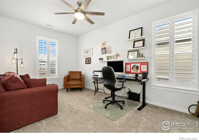 office area featuring light carpet and ceiling fan