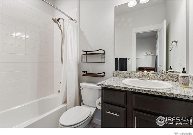 full bathroom featuring shower / bath combo, vanity, and toilet