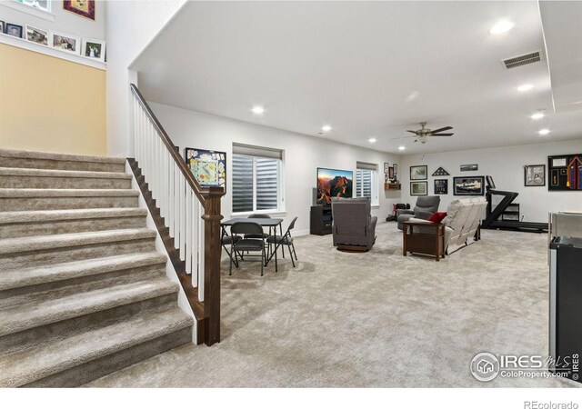 carpeted living room featuring ceiling fan