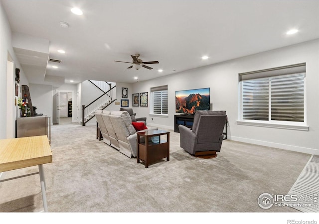 living room featuring ceiling fan and light colored carpet