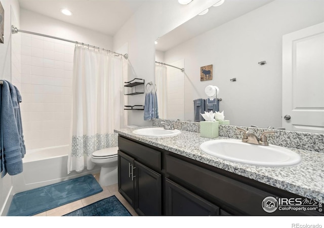 full bathroom featuring shower / tub combo with curtain, tile patterned floors, toilet, and vanity