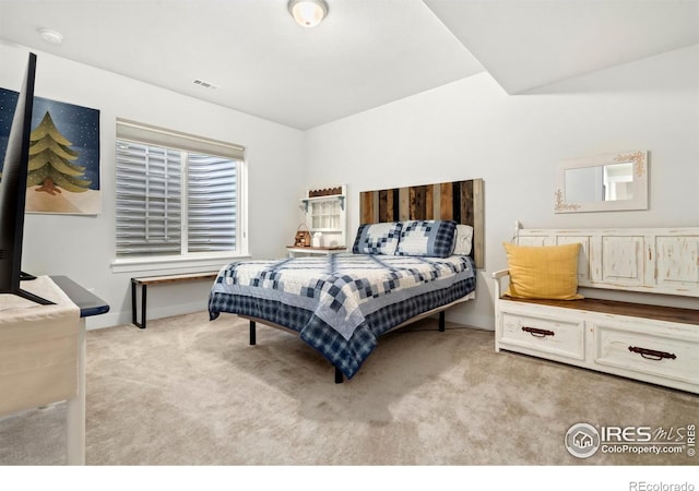 bedroom featuring light colored carpet