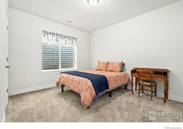 bedroom featuring light carpet