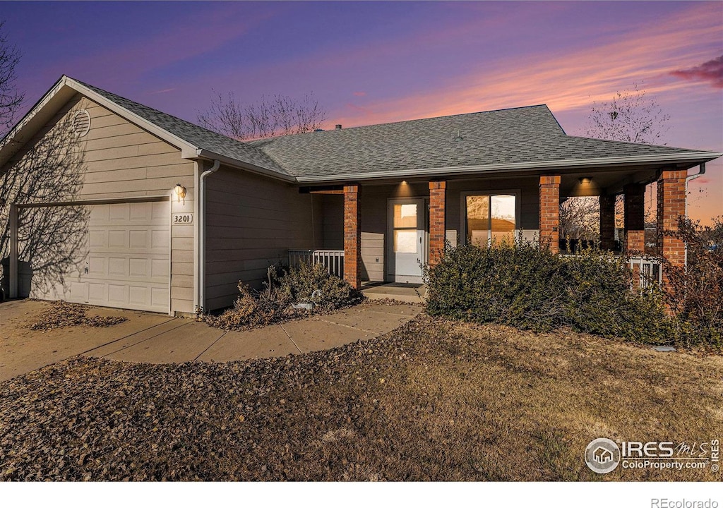 single story home with a garage and covered porch