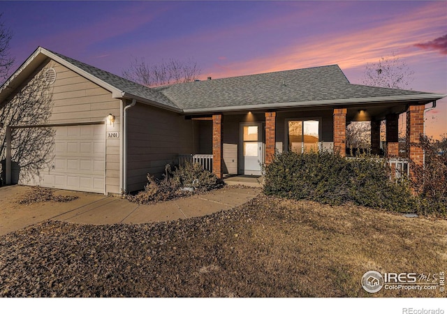 single story home with a garage and covered porch