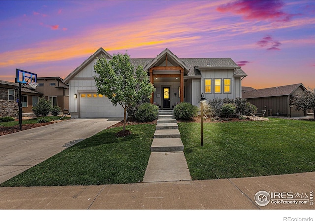 view of front of property featuring a garage and a lawn