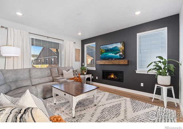 living room with a wealth of natural light and light wood-type flooring