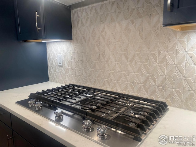 details featuring tasteful backsplash and stainless steel gas stovetop