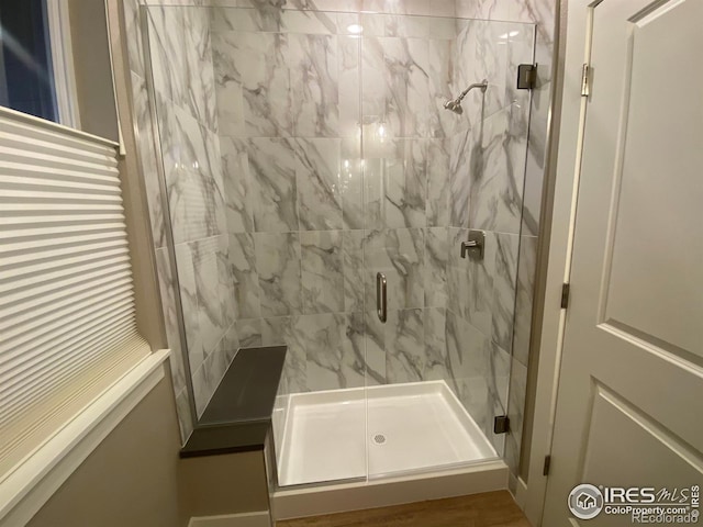 bathroom with a shower with shower door