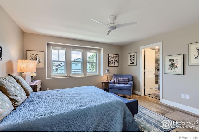 bedroom with ceiling fan, ensuite bathroom, and light hardwood / wood-style floors