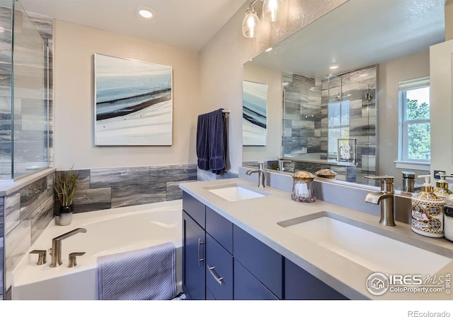 bathroom with vanity and separate shower and tub