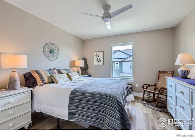 bedroom with ceiling fan and light hardwood / wood-style floors