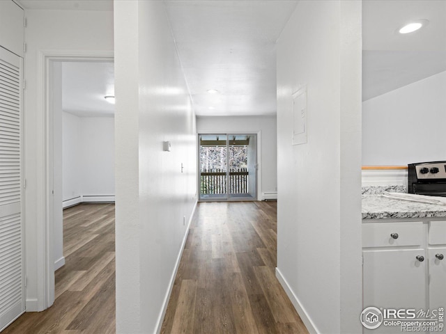 hallway with wood-type flooring and a baseboard radiator