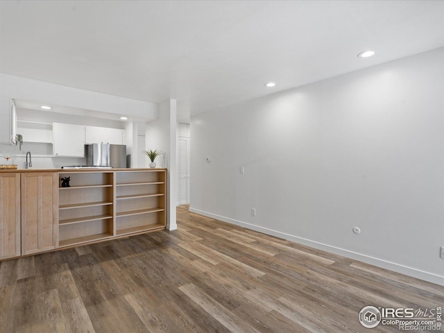 interior space featuring dark hardwood / wood-style flooring and sink