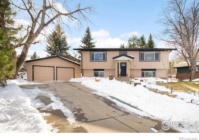 split foyer home with a garage and an outdoor structure