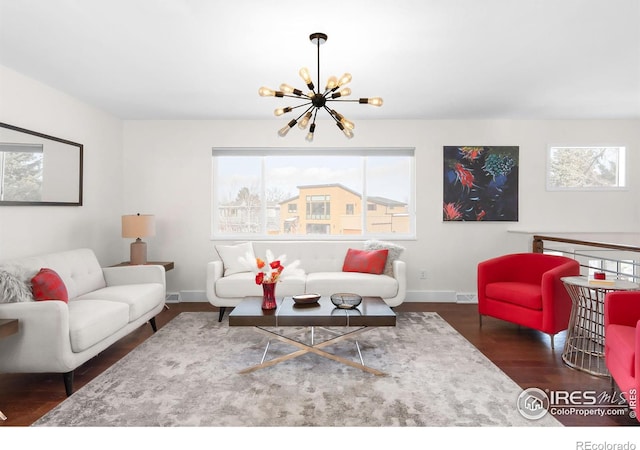 living room featuring dark wood-type flooring and an inviting chandelier