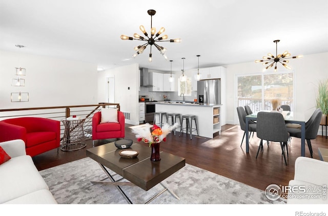 living room with a notable chandelier and dark wood-type flooring