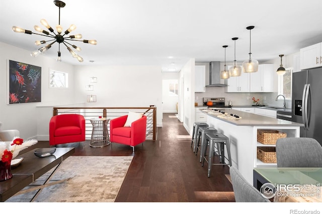 living room with sink, dark hardwood / wood-style floors, and a chandelier