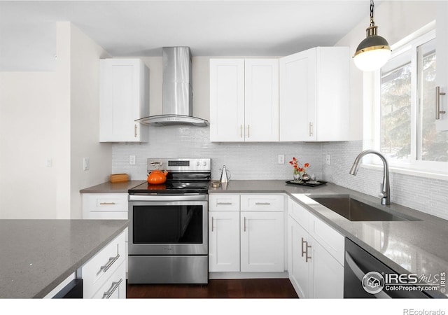 kitchen with sink, stainless steel range with electric cooktop, white cabinetry, light stone counters, and wall chimney range hood