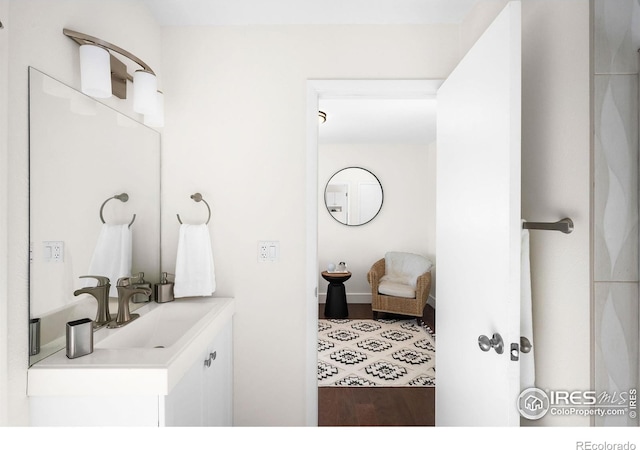 bathroom with hardwood / wood-style flooring and vanity