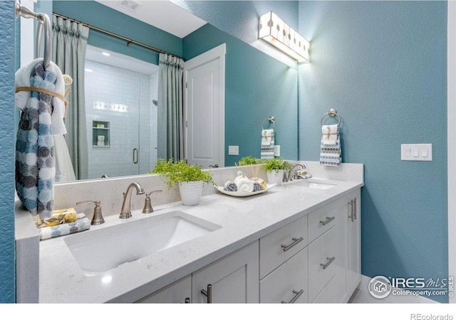 bathroom with vanity and a tile shower