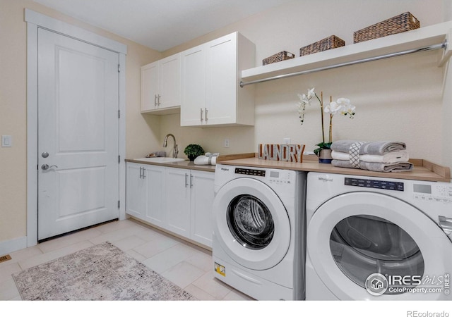 laundry room featuring separate washer and dryer, sink, cabinets, and light tile patterned flooring