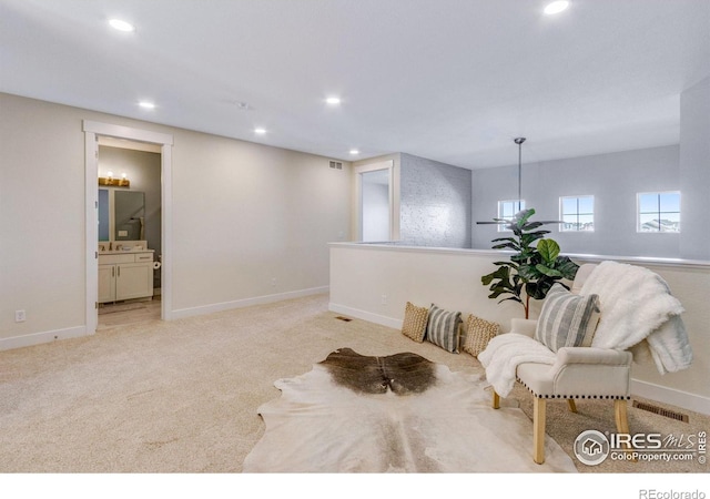 living area featuring light carpet