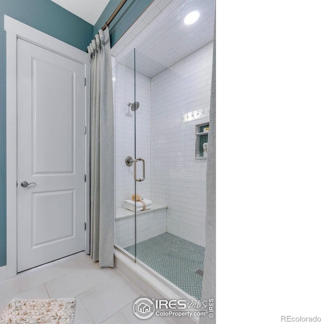 bathroom featuring tile patterned floors and a shower with shower curtain