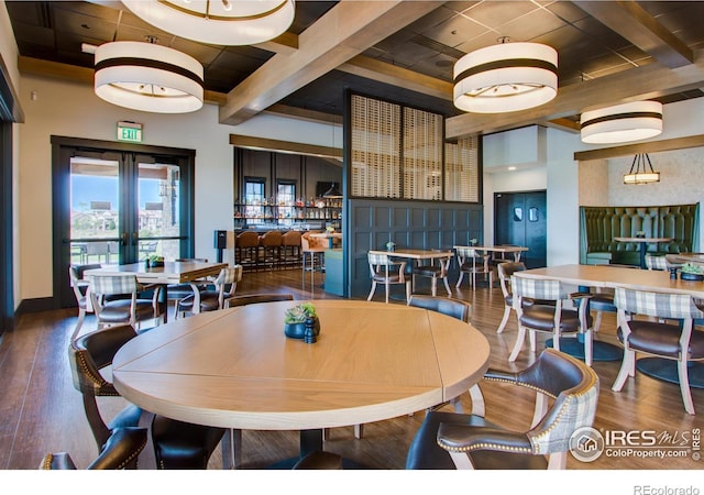 dining area featuring coffered ceiling, beam ceiling, dark hardwood / wood-style floors, and french doors