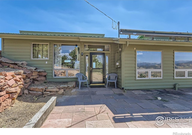 entrance to property featuring a patio