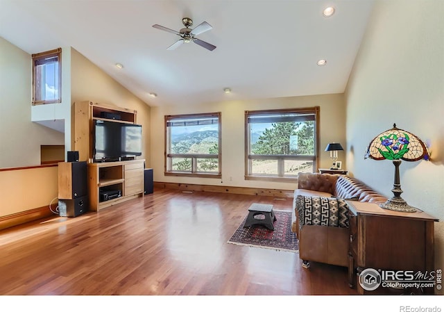 living room with wood-type flooring, high vaulted ceiling, and ceiling fan