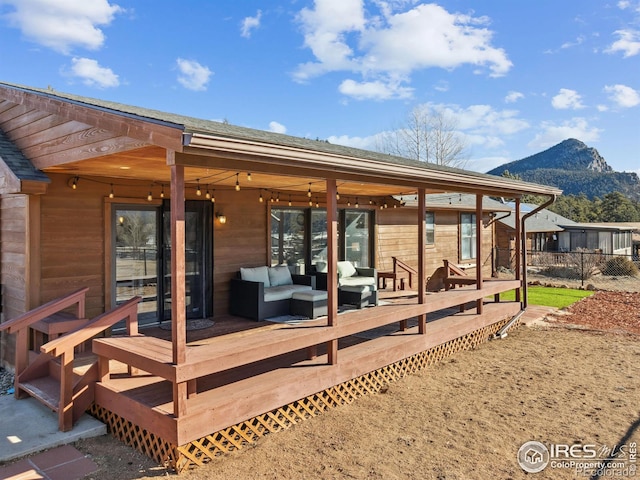 rear view of house with an outdoor hangout area and a deck with mountain view