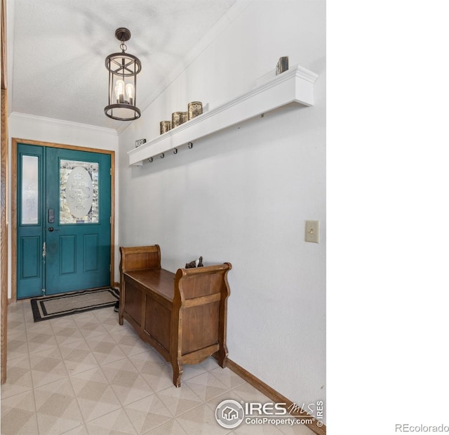 interior space featuring crown molding and an inviting chandelier